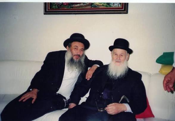 Two rabbis seated together on a sofa
