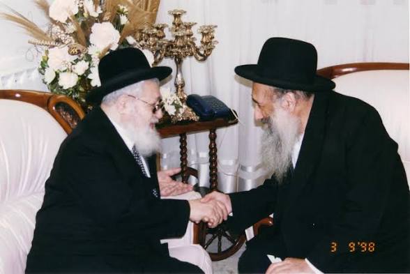 Two rabbis greeting each other and shaking hands